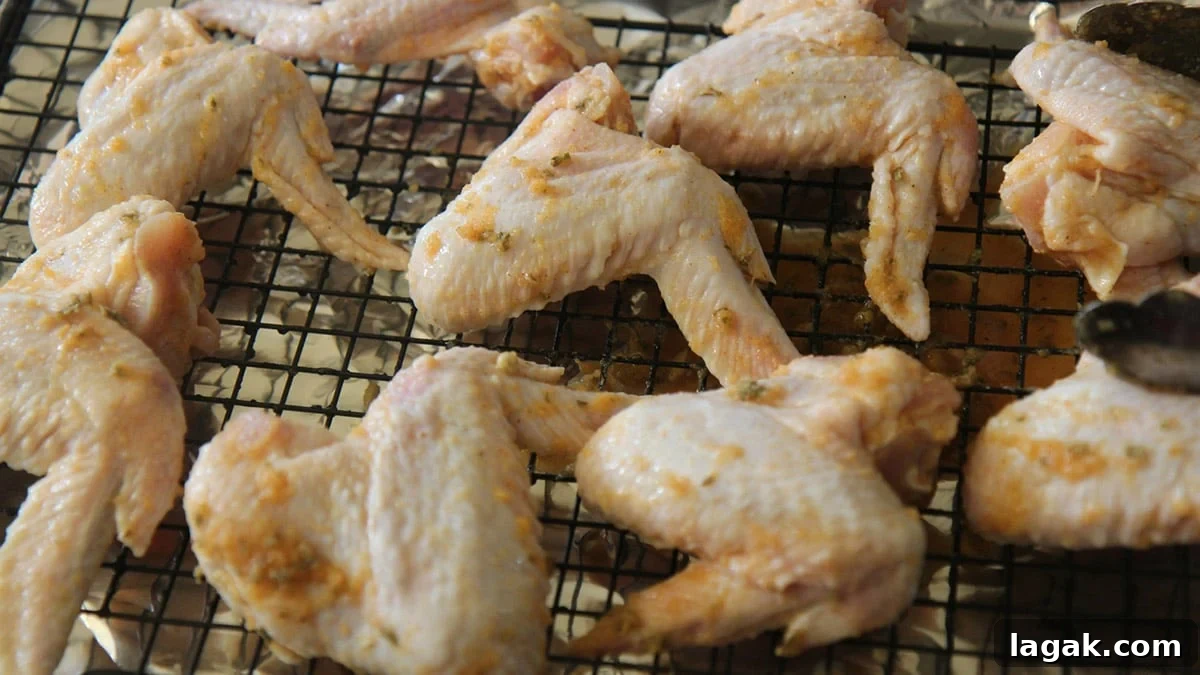 raw chicken marinated on a baking sheet.