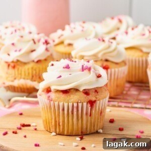 Perfect Pink Cupcake Recipe: Moist, Fluffy Frosting Ideas 12 White cupcakes with pink sprinkles baked in the batter, then frosted with white frosting and topped with pink sprinkles.