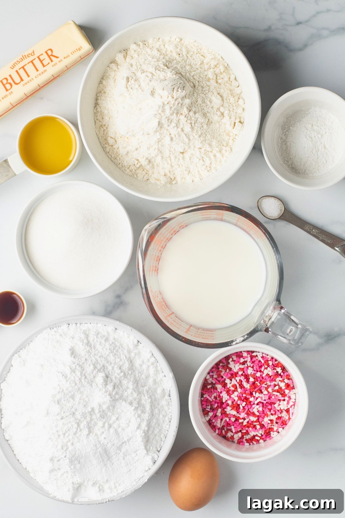 Perfect Pink Cupcake Recipe: Moist, Fluffy Frosting Ideas 3 Ingredients needed to make vanilla cupcakes from scratch with pink sprinkles in small white bowls.