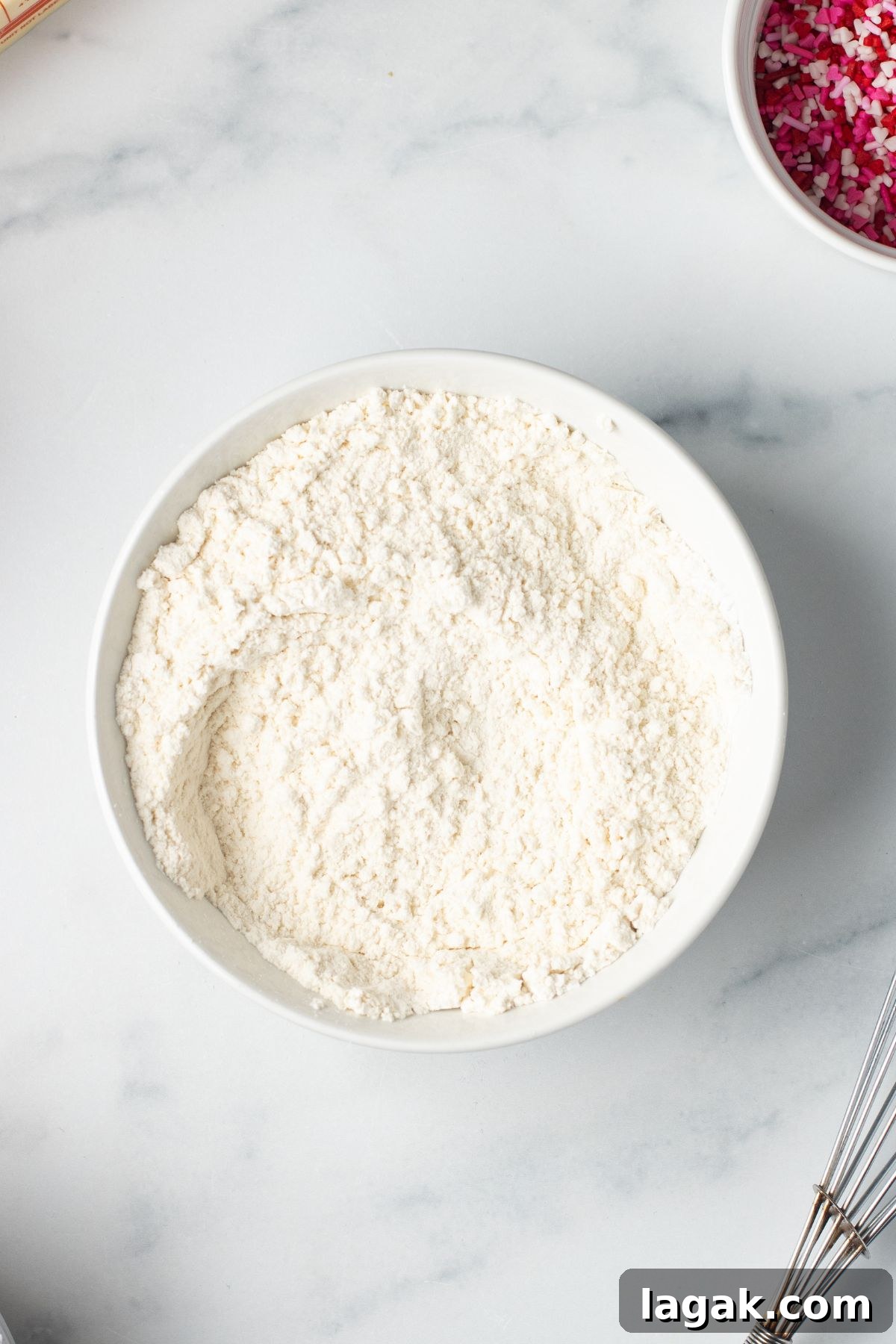 Perfect Pink Cupcake Recipe: Moist, Fluffy Frosting Ideas 4 Dry ingredients for cupcakes mixed in white mixing bowls.