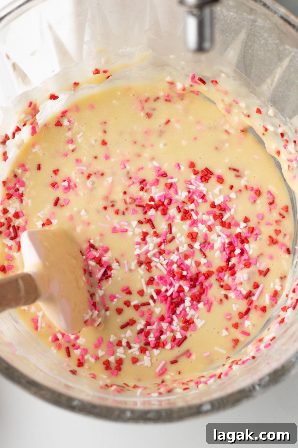 Perfect Pink Cupcake Recipe: Moist, Fluffy Frosting Ideas 6 Pink sprinkles mixed in the with cupcake batter in mixing bowl.