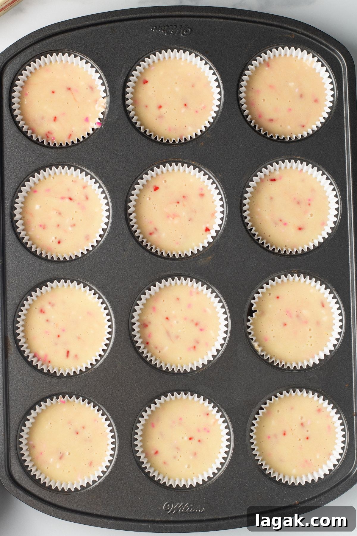 Perfect Pink Cupcake Recipe: Moist, Fluffy Frosting Ideas 7 Cupcake batter in a muffin tin before baking.