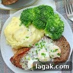 Air Fryer Steak with Creamy Garlic Shrimp Sauce 8 air fryer steak topped with three shrimp and cream sauce plated with mashed potatoes and broccoli