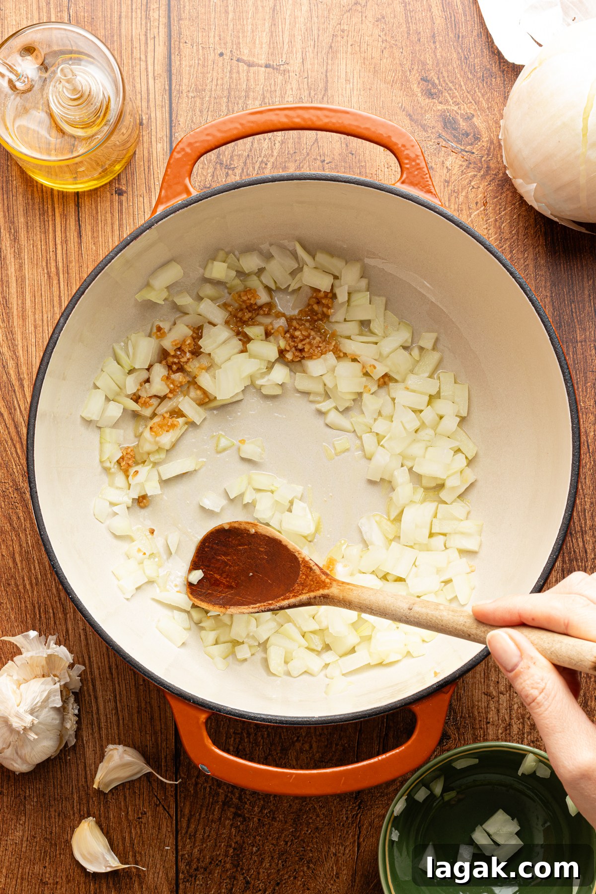 30-Minute High-Protein Turkey Chili Recipe 3 A large pot filled with diced white onions and garlic