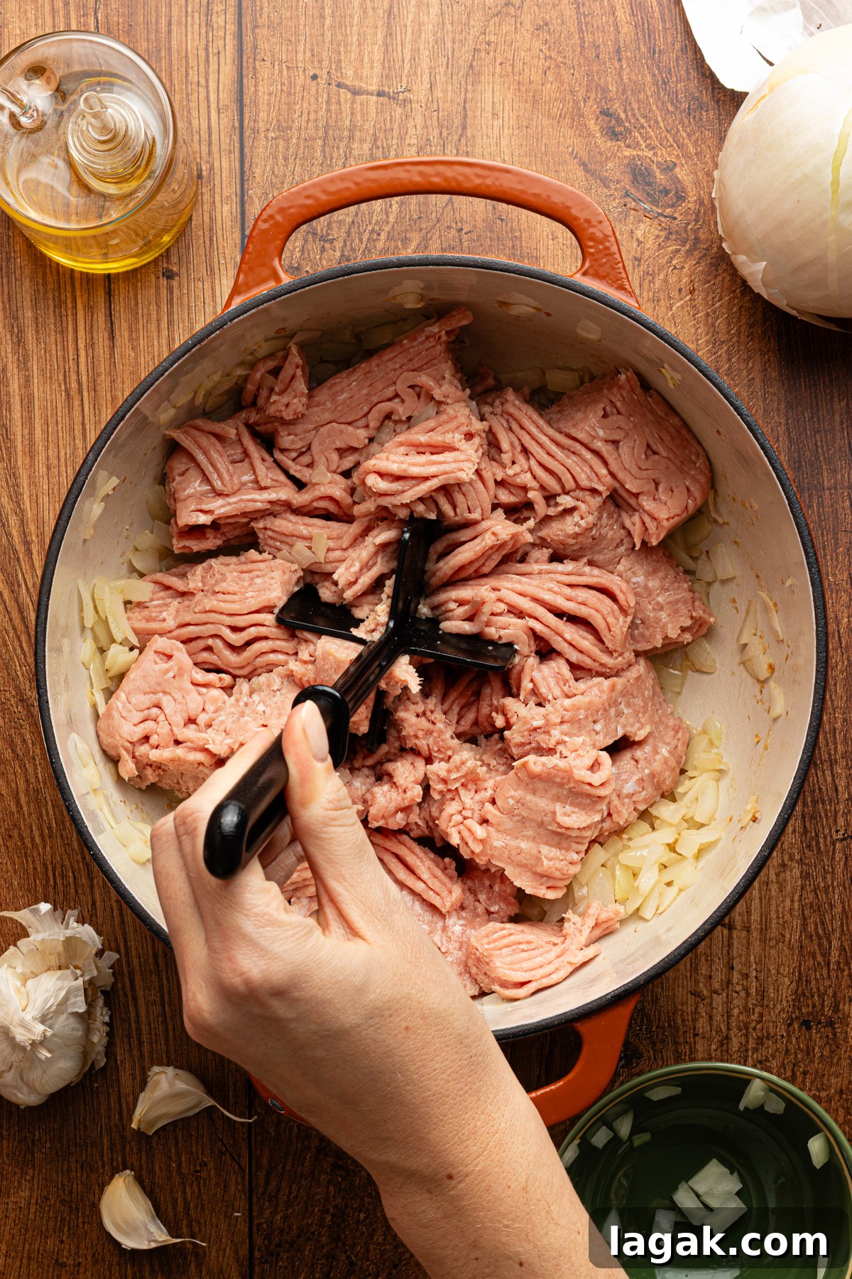 30-Minute High-Protein Turkey Chili Recipe 5 A large pot filled with sauteed onions and garlic with ground turkey added
