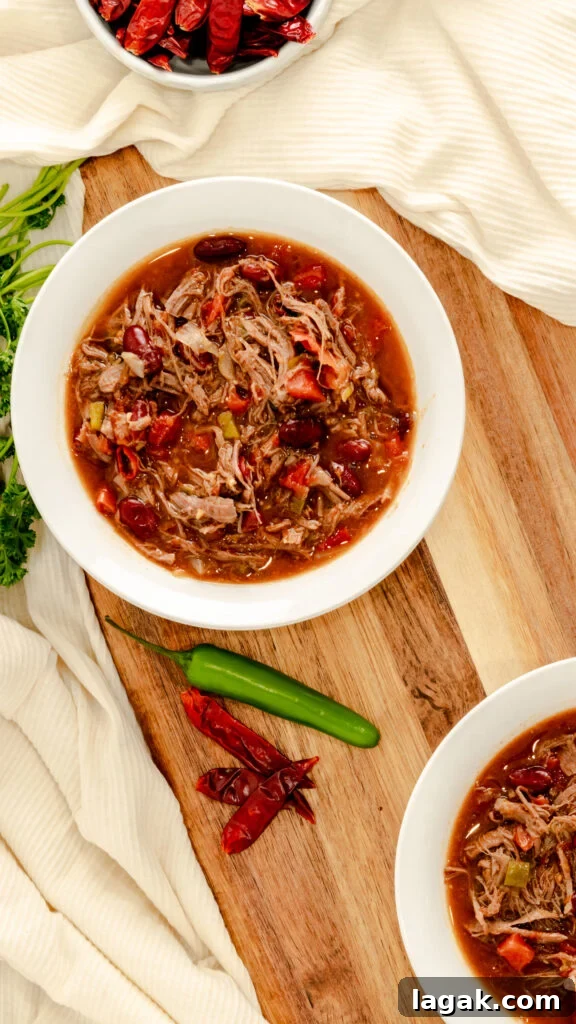 Spicy Venison Chili in the Instant Pot: Quick Pressure-Cooker Recipe 3 Flat lay of two bowls of instant pot chili served with red chilies and Serrano peppers.