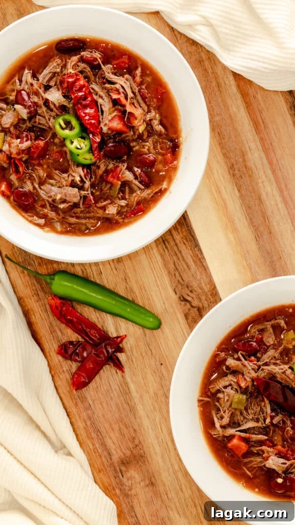 Spicy Venison Chili in the Instant Pot: Quick Pressure-Cooker Recipe 5 Spicy chili garnished with serrano peppers, cheese, and parsley.