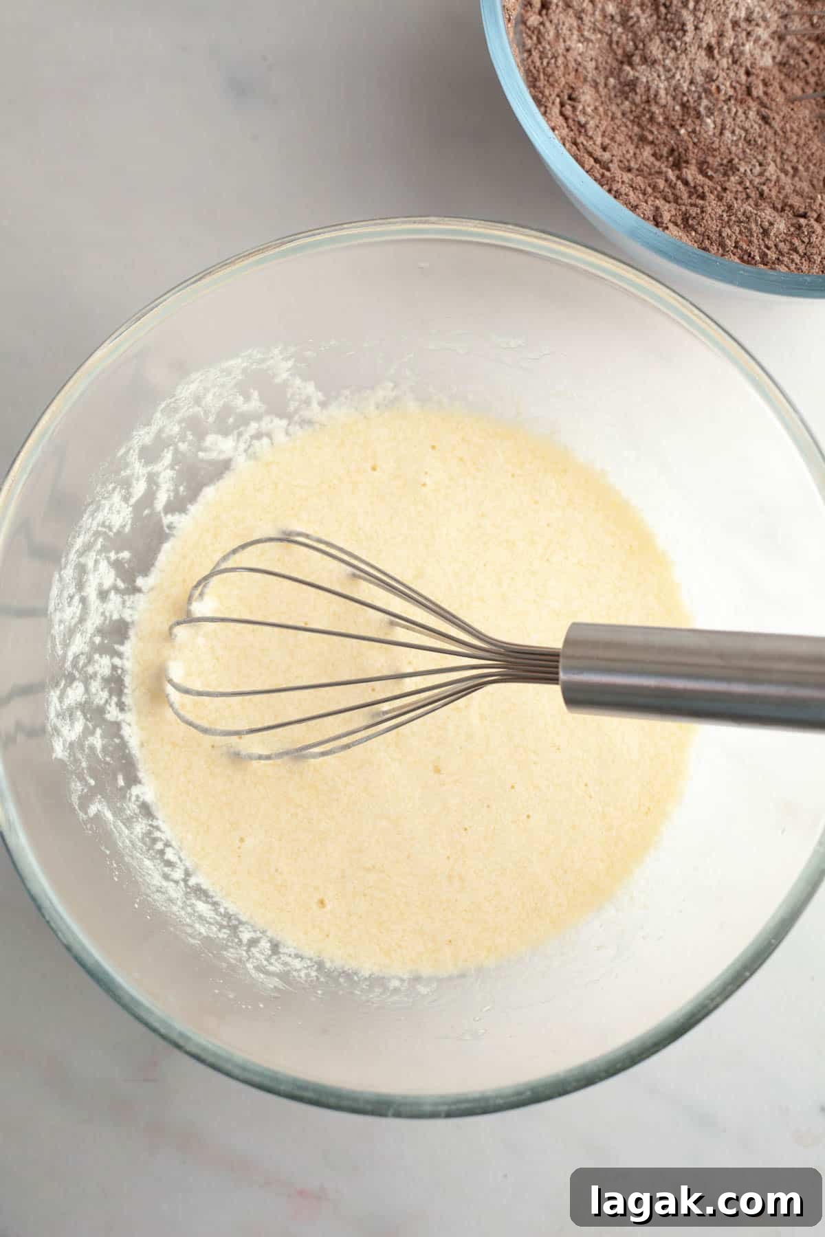 Moist Chocolate Cupcakes with Cream Cheese Frosting Recipe 5 Whisked pale yellow mixture in a bowl with a whisk.