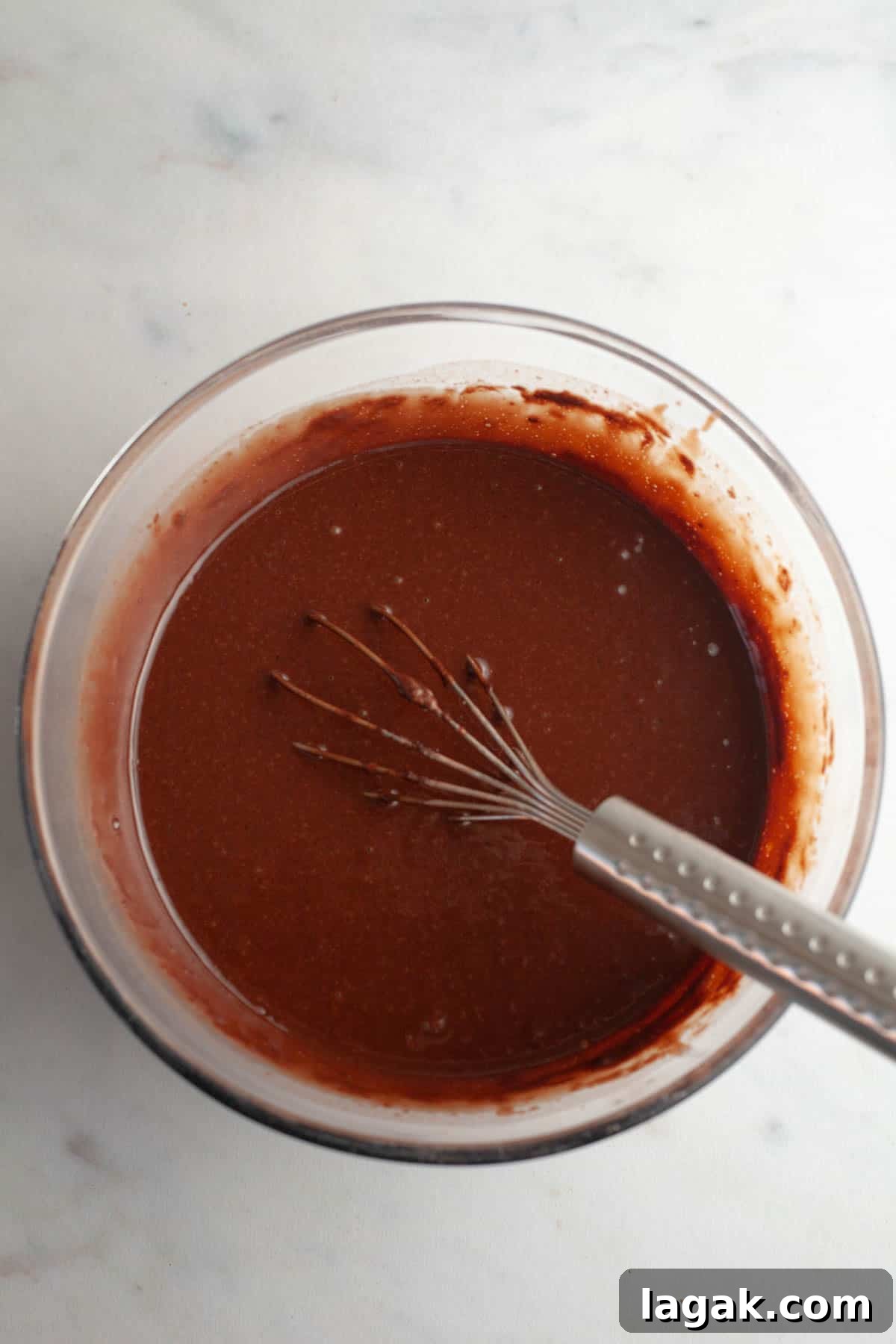 Moist Chocolate Cupcakes with Cream Cheese Frosting Recipe 6 Chocolate cupcake batter in a bowl with a whisk.