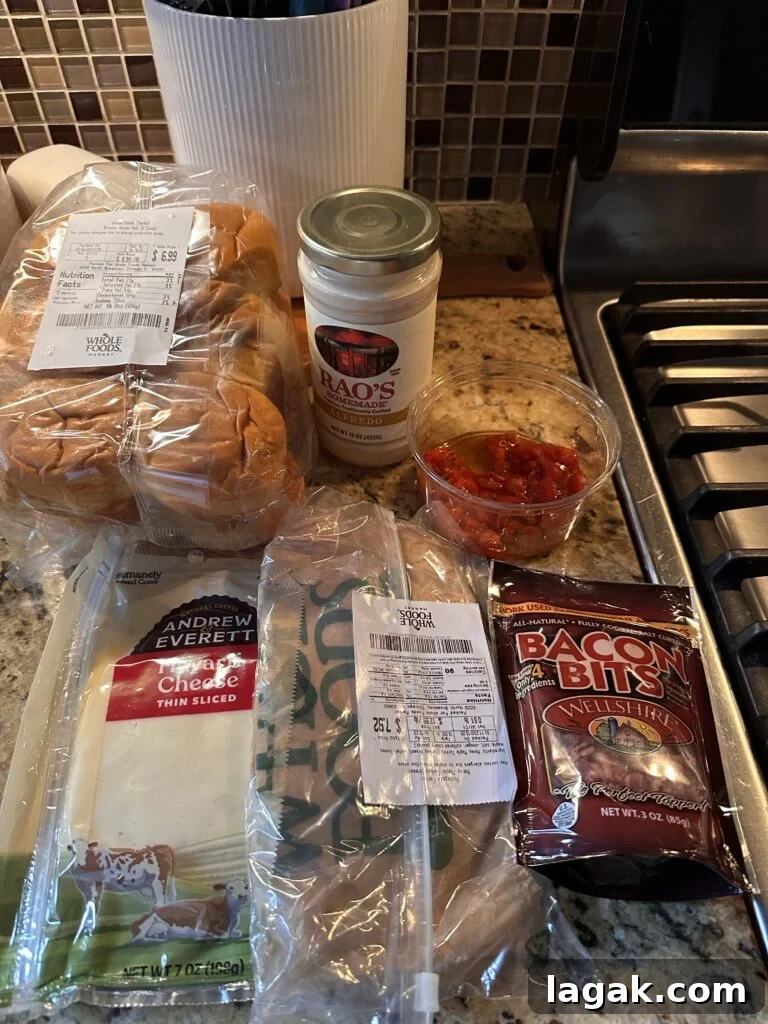Derby Day Hot Brown Sliders Recipe for Kentucky Party Bites 3 The ingredients for the hot brown sliders, including bacon bits, cheese alfredo sauce, buns, and deli turkey