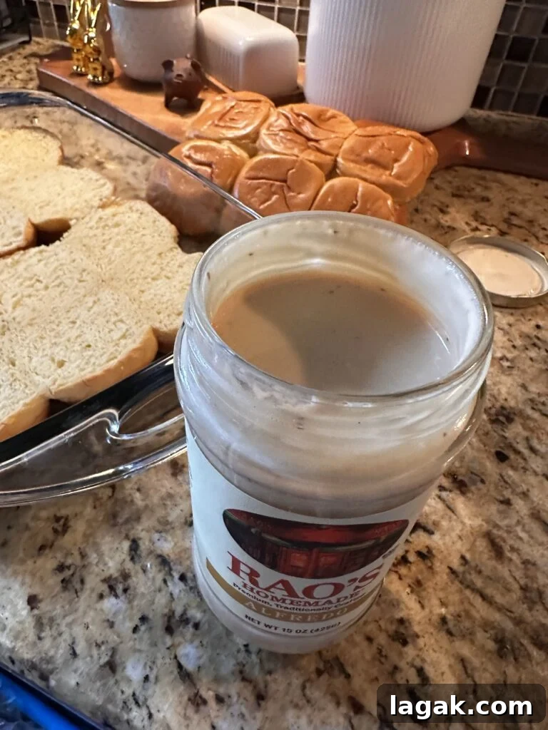 Derby Day Hot Brown Sliders Recipe for Kentucky Party Bites 4 An open jar of alfredo sauce next to buns in a glass baking dish