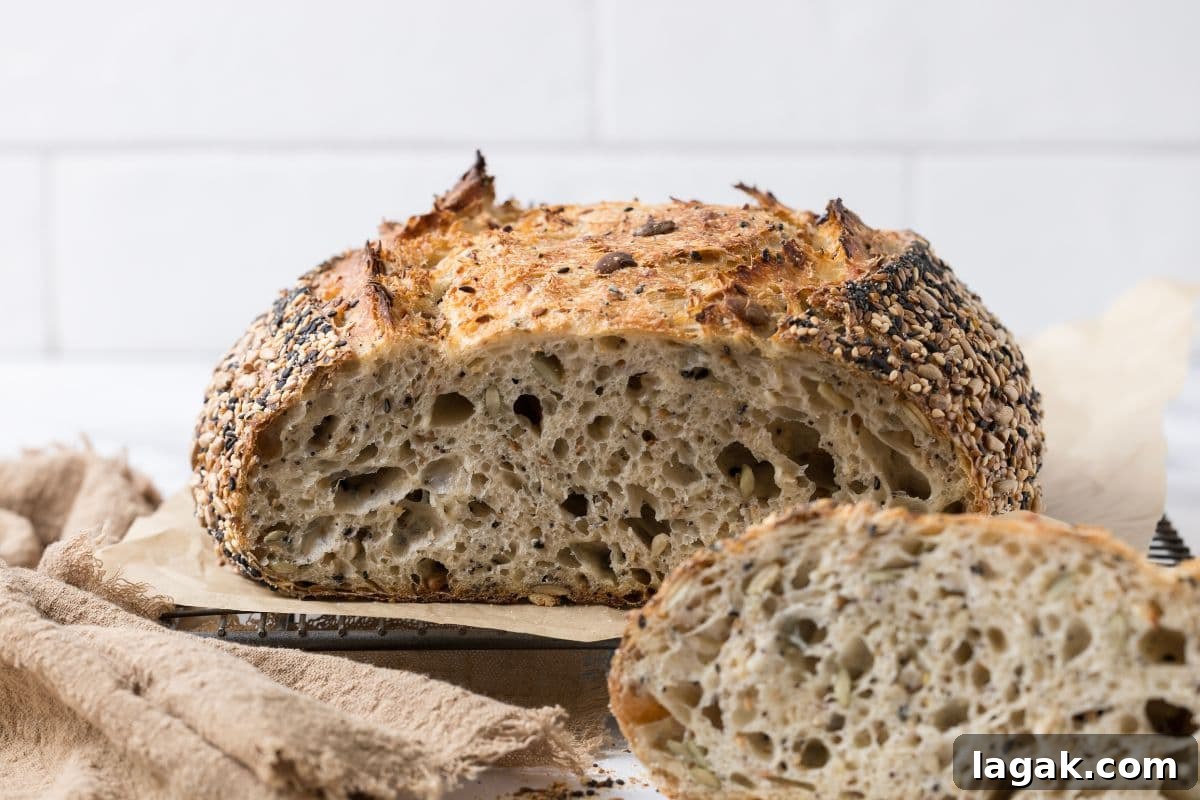 Multigrain Sourdough Bread: Step-by-Step Artisan Recipe 2 Close up of a sliced open loaf of multigrain sourdough bread to show perfect sourdough texture.