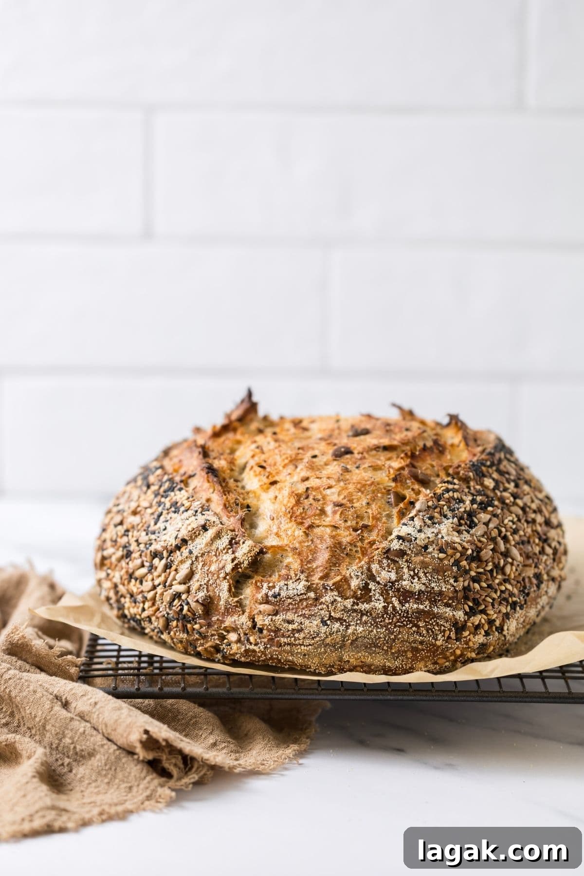 Multigrain Sourdough Bread: Step-by-Step Artisan Recipe 12 A whole loaf of fresh baked multigrain sourdough bread on a cooling rack.