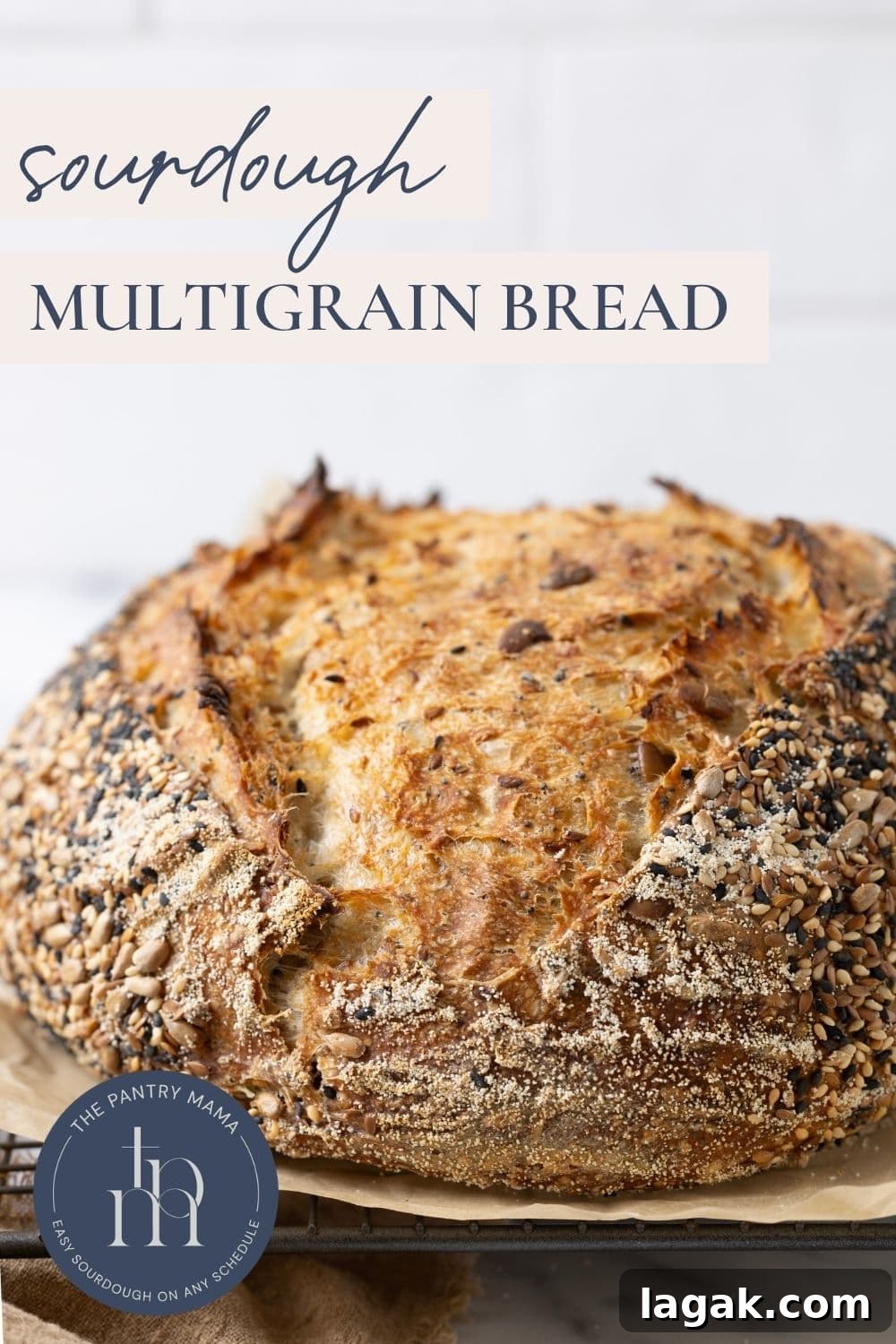 Multigrain Sourdough Bread: Step-by-Step Artisan Recipe 13 Load of multigrain sourdough bread on a piece of parchment paper with text overlay for a Pinterest Pin.