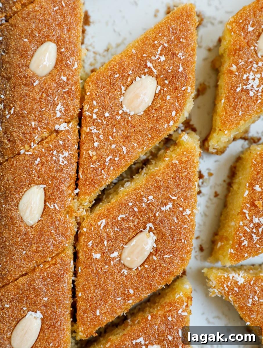 Coconut Basbousa Recipe: Moist Semolina Cake with Syrup 2 Close up of Coconut Basbousa cut into slices.