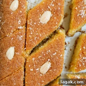 Coconut Basbousa Recipe: Moist Semolina Cake with Syrup 9 Close up of Coconut Basbousa cut into slices.