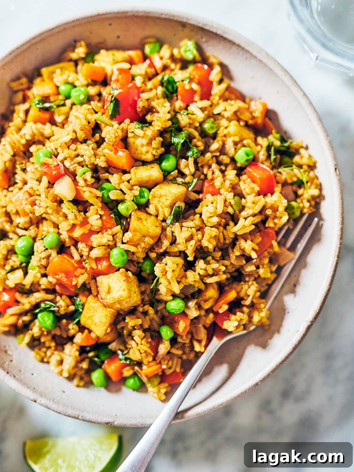 Thai Green Curry Fried Rice in a bowl with a fork.