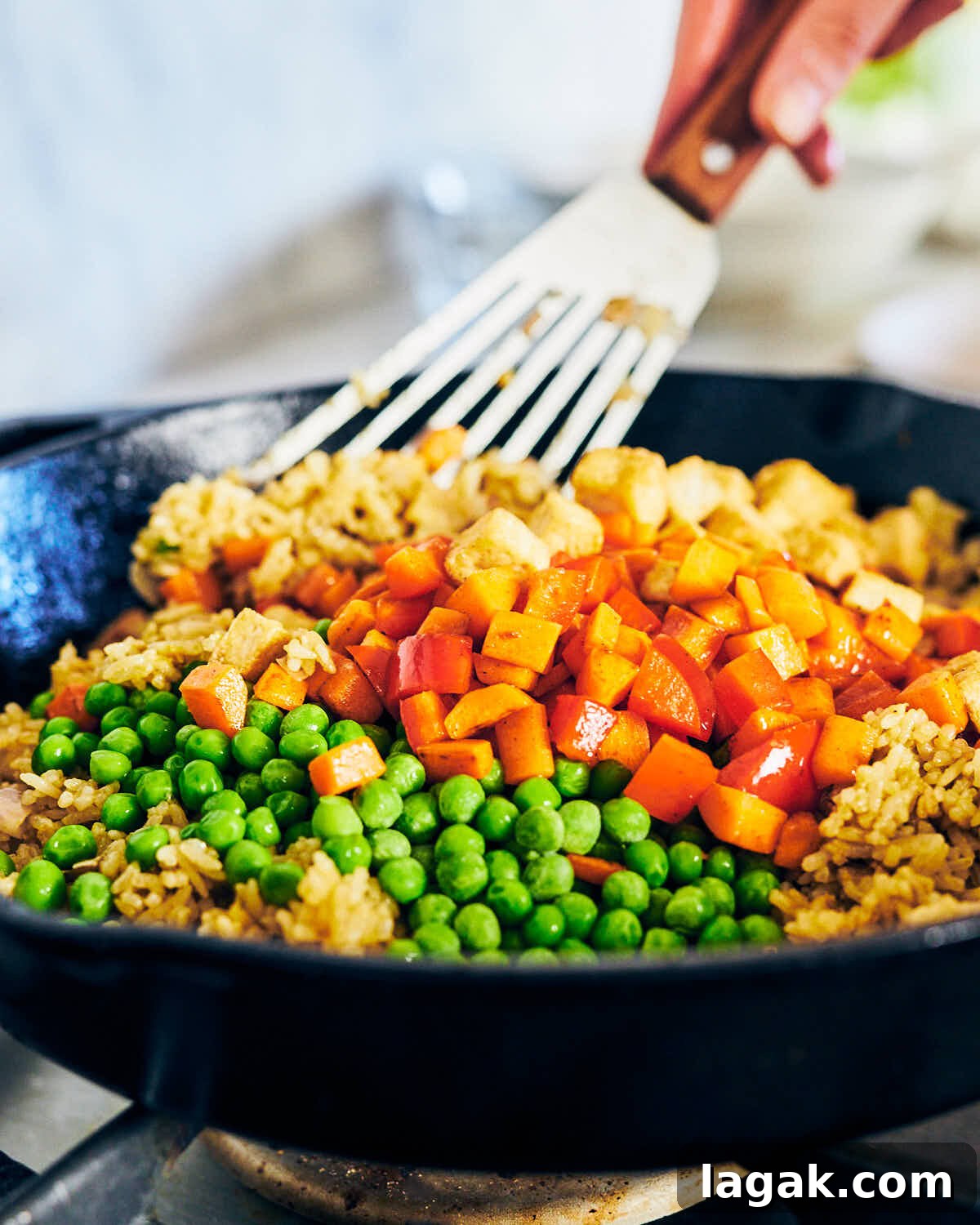 Stirring vegetables into Thai Green Curry Fried Rice.