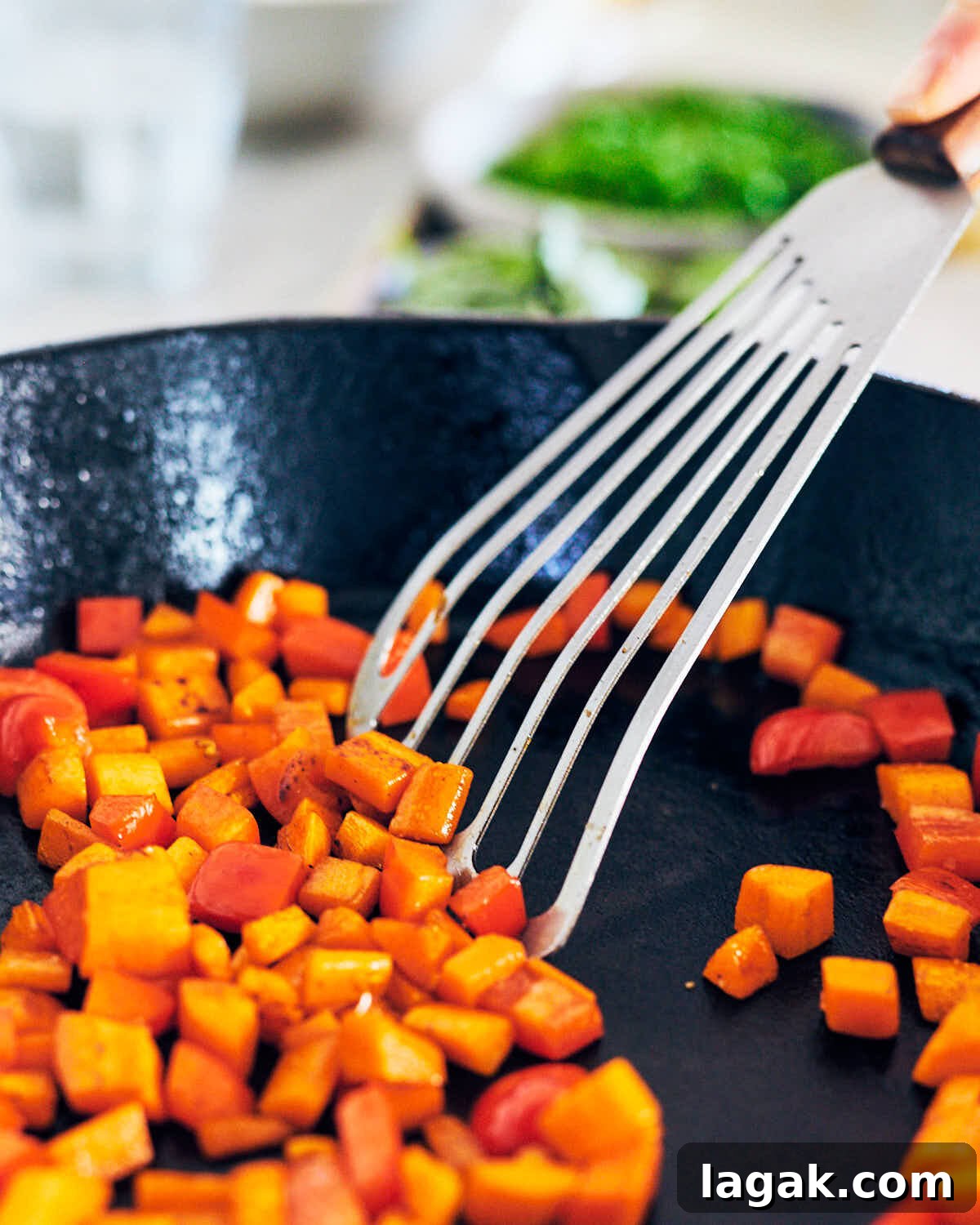 Sautéing carrots and red bell pepper for Thai Green Curry Fried Rice.