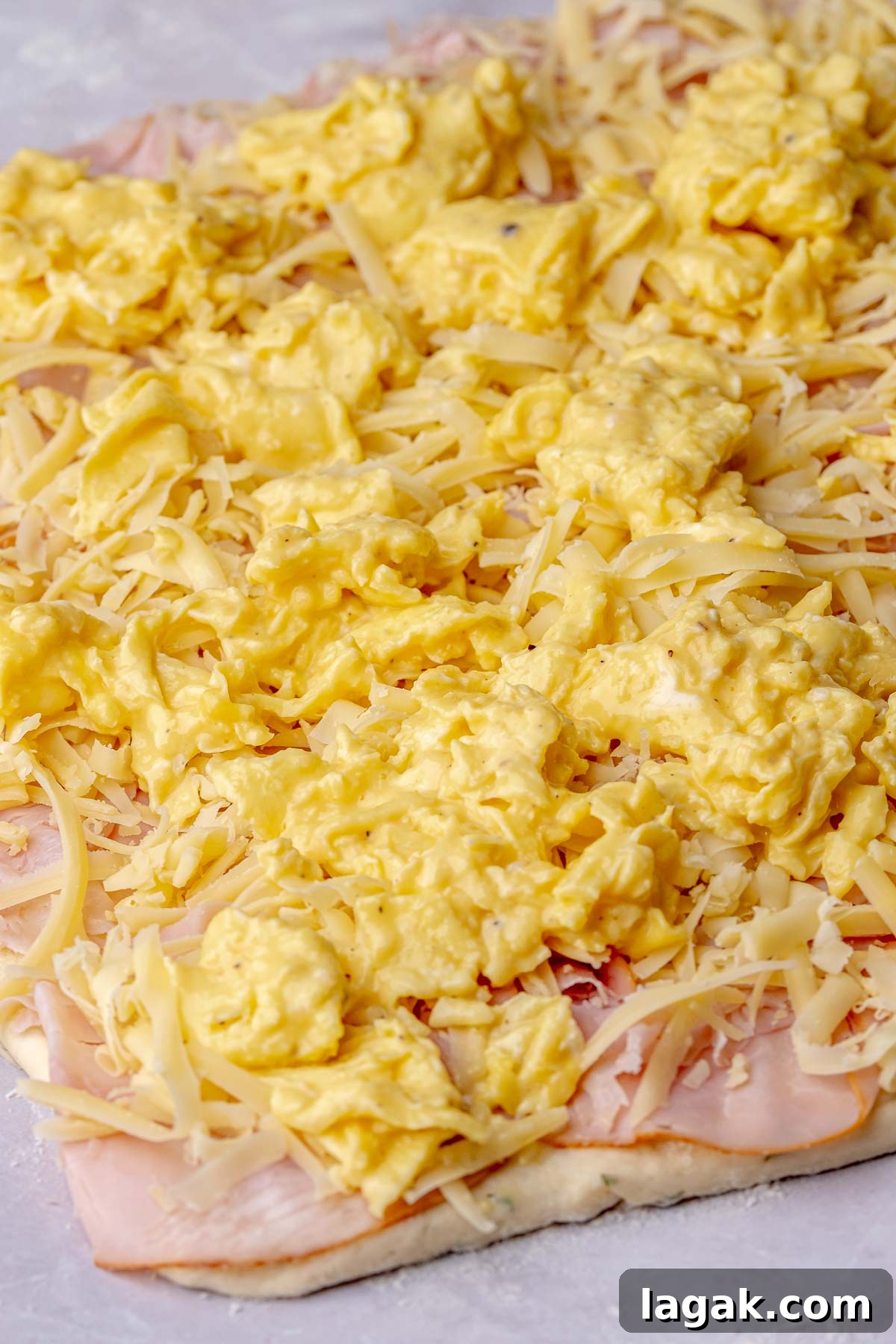 Savory Breakfast Rolls with Creamy Hollandaise Sauce 12 Scrambled eggs on top of ham and cheese.