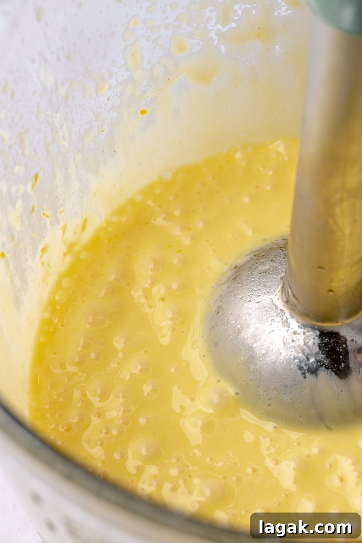 Savory Breakfast Rolls with Creamy Hollandaise Sauce 15 A blender combining hollandaise sauce in a bowl.