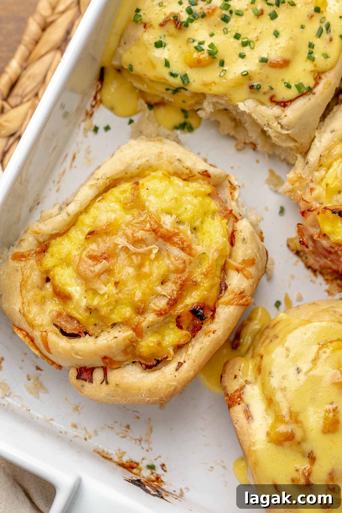 Savory Breakfast Rolls with Creamy Hollandaise Sauce 16 Baked savory roll in a casserole dish.