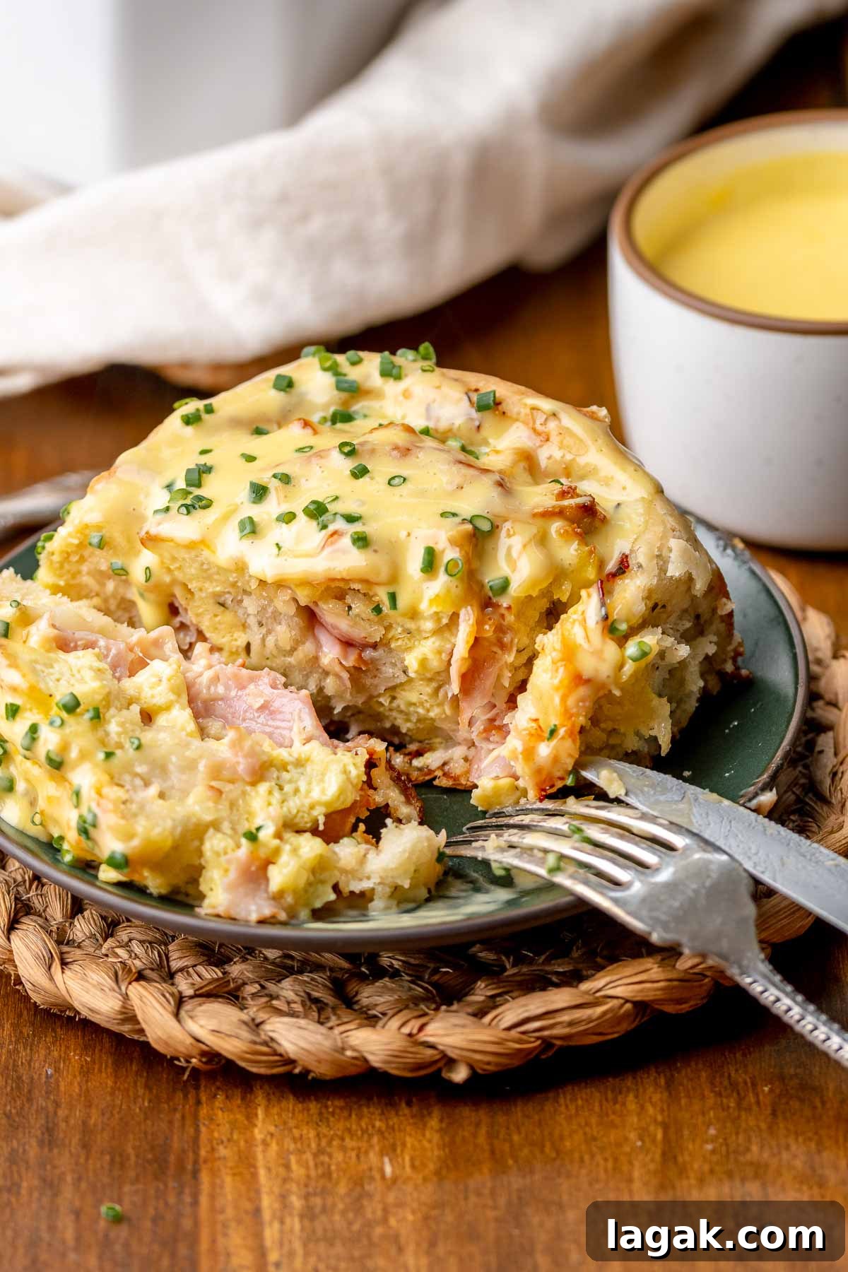 Savory Breakfast Rolls with Creamy Hollandaise Sauce 18 Cut open savory cinnamon roll on a plate.