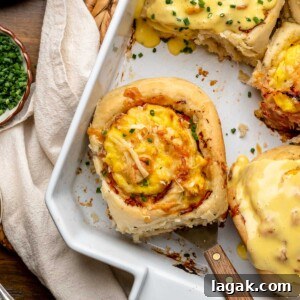 Savory Breakfast Rolls with Creamy Hollandaise Sauce 23 A savory breakfast roll in a casserole dish, sitting on a spatula.
