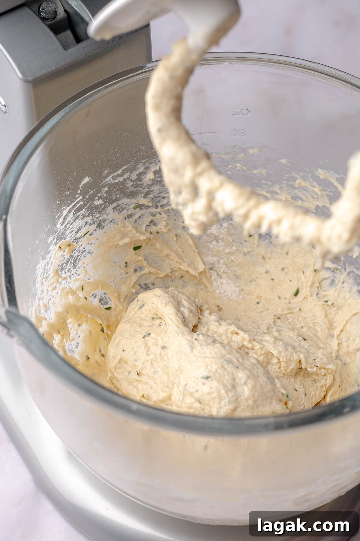 Savory Breakfast Rolls with Creamy Hollandaise Sauce 7 Herbed cinnamon roll dough in a bowl with a dough hook.