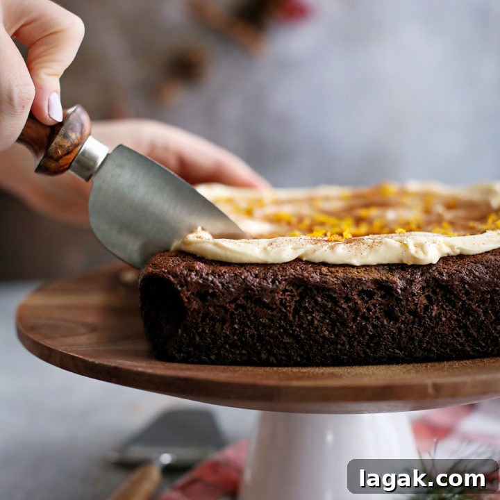 woman slicing a chocolate gingerbread cake