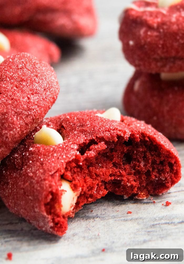 Red Velvet Cake Mix Cookies – Quick Moist Red Velvet Treats 4 Partially Eaten White Chocolate Chip Cake Mix Cookies on Rustic Gray Background