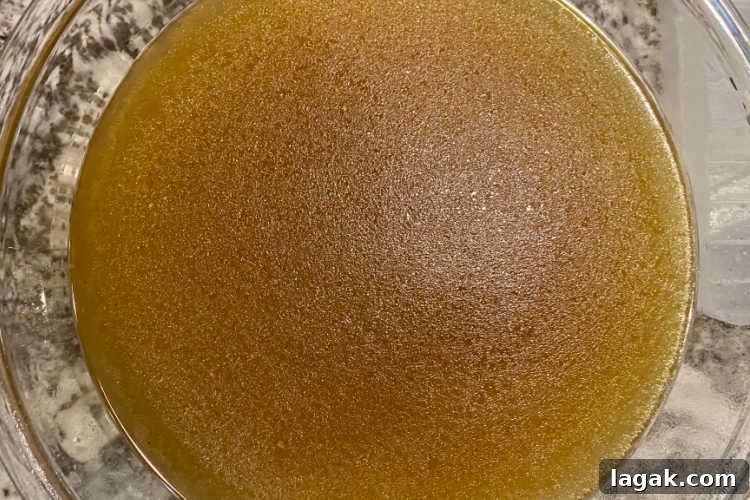 Instant Pot Rotisserie Chicken Soup Recipe for Comforting Meals 4 bowl of homemade chicken stock on the counter