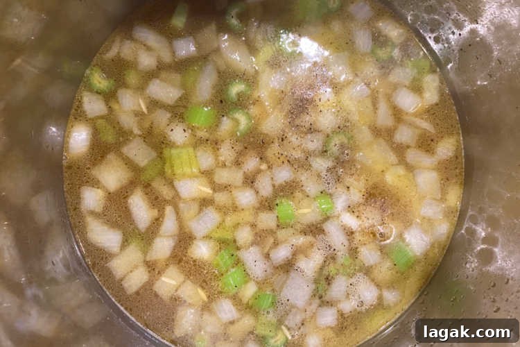Instant Pot Rotisserie Chicken Soup Recipe for Comforting Meals 6 chicken broth with onions and celery in instant pot