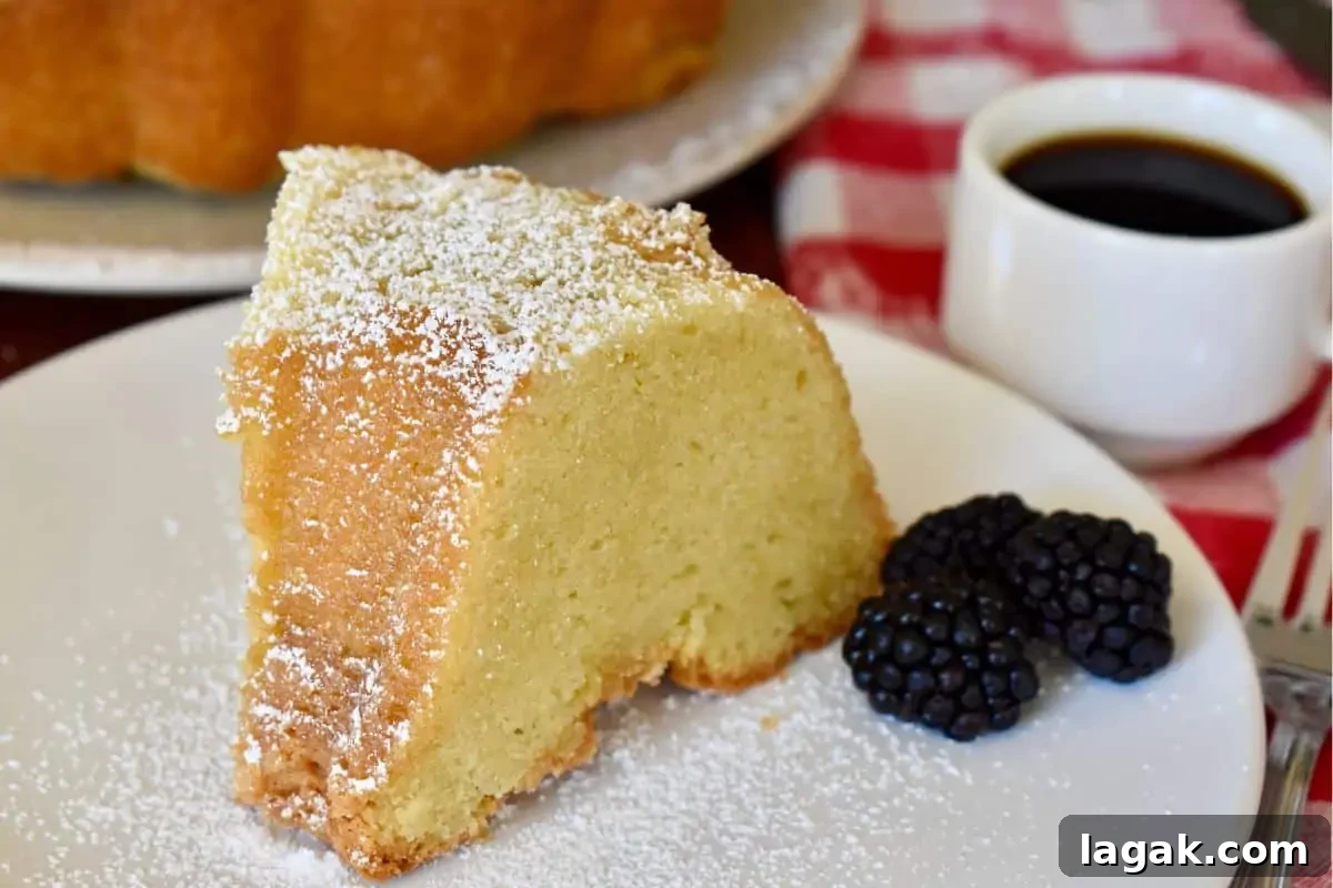 Mascarpone Pound Cake Recipe: Moist Italian Cream Cake with Mascarpone 3 Mascarpone Pound Cake on a white plate with blackberries next to it.