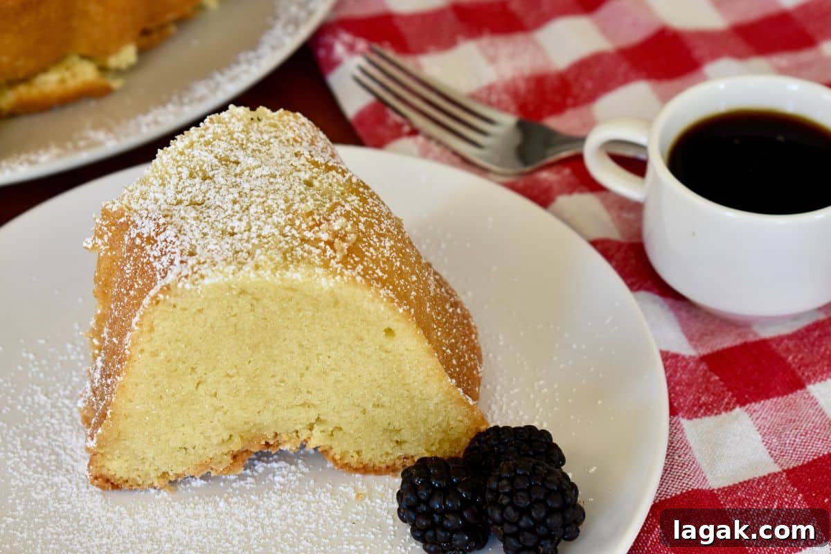 Mascarpone Pound Cake Recipe: Moist Italian Cream Cake with Mascarpone 7 Mascarpone Pound Cake on a white plate with a checkered napkin in the background.