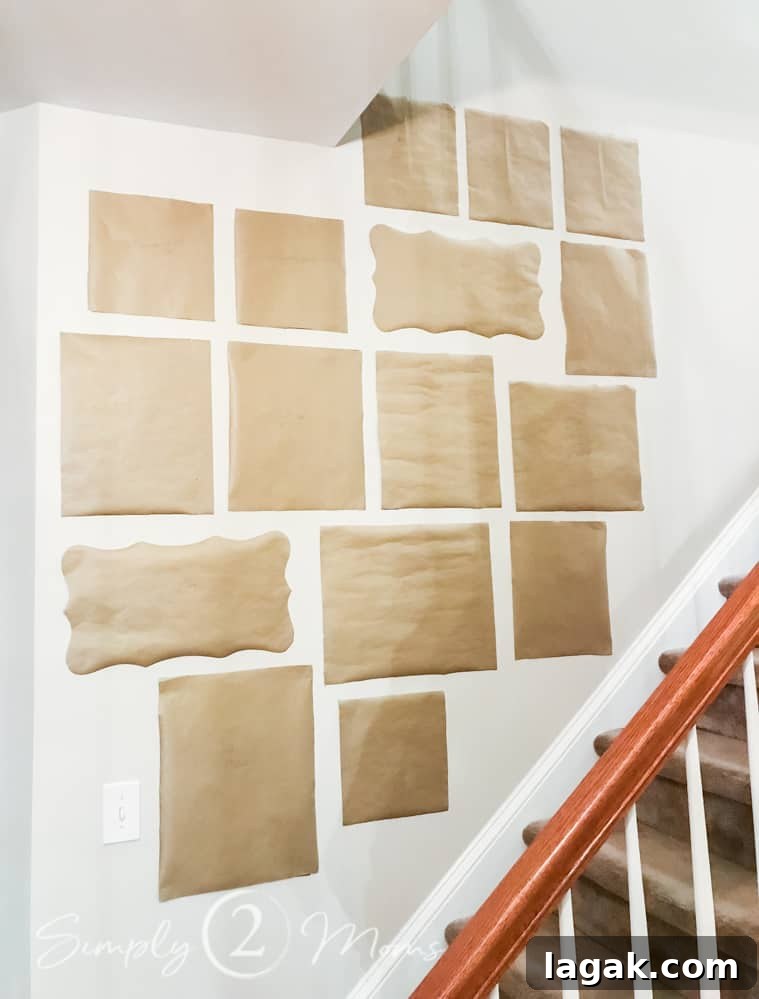 kraft paper photo frame templates taped on wall in staircase for gallery wall