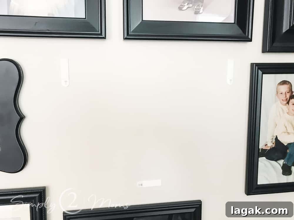 command strips attached to wall before securing frame to command strip