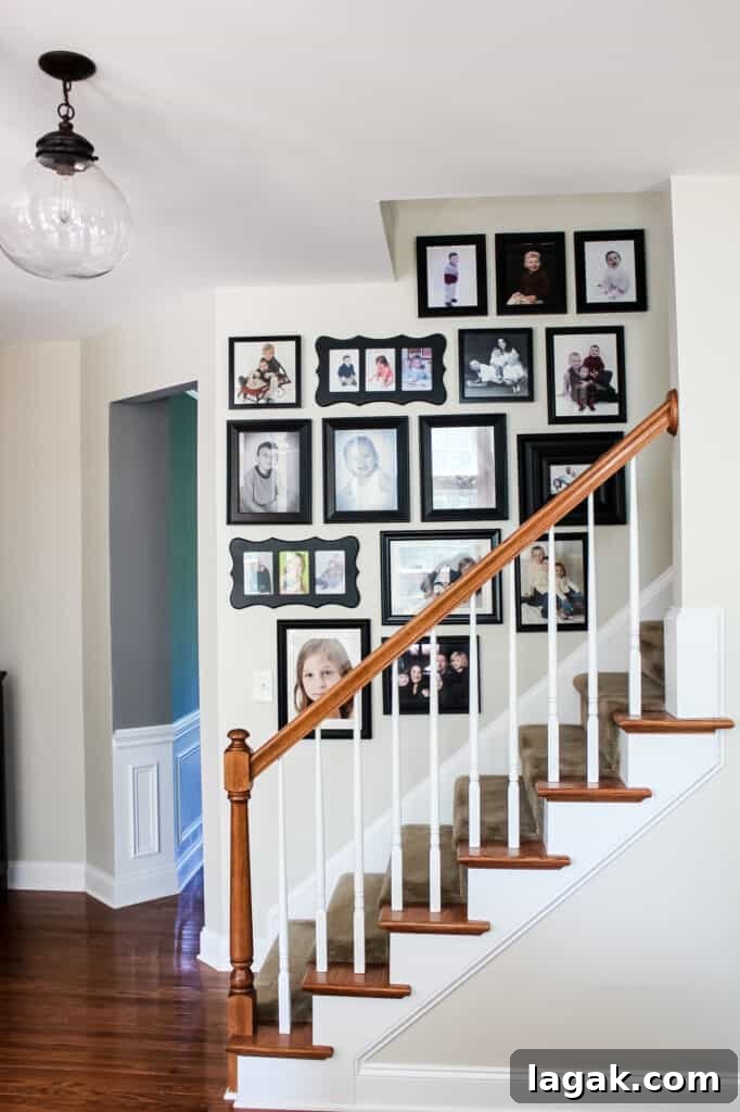 gallery wall going up staircase hanging glass light fixtur
