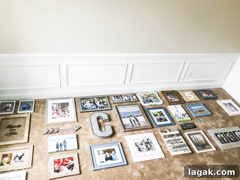 photo frames and wall art work laying on carpeted floor in front of wall with picture frame moulding