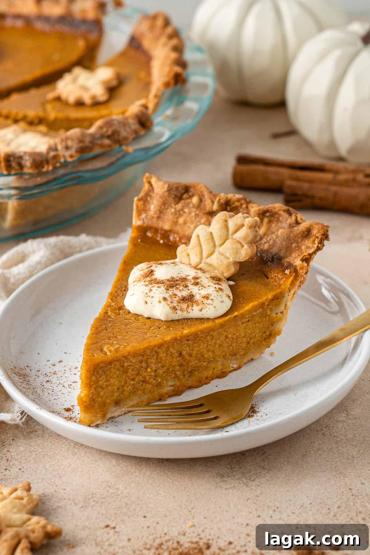 Creamy Dairy-Free Pumpkin Pie Recipe for Fall Celebrations 11 A slice of pumpkin pie on a plate with a fork.
