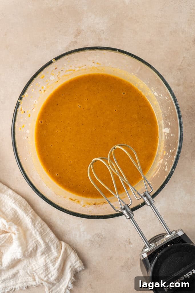Creamy Dairy-Free Pumpkin Pie Recipe for Fall Celebrations 7 Mixing the pie filling with electric beaters.