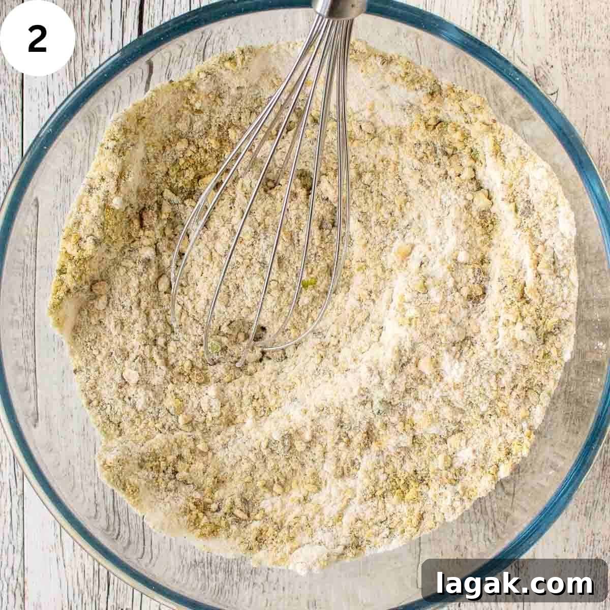 Moist Pistachio Muffins with Lemon Glaze 5 Mixing dry ingredients with a whisk.