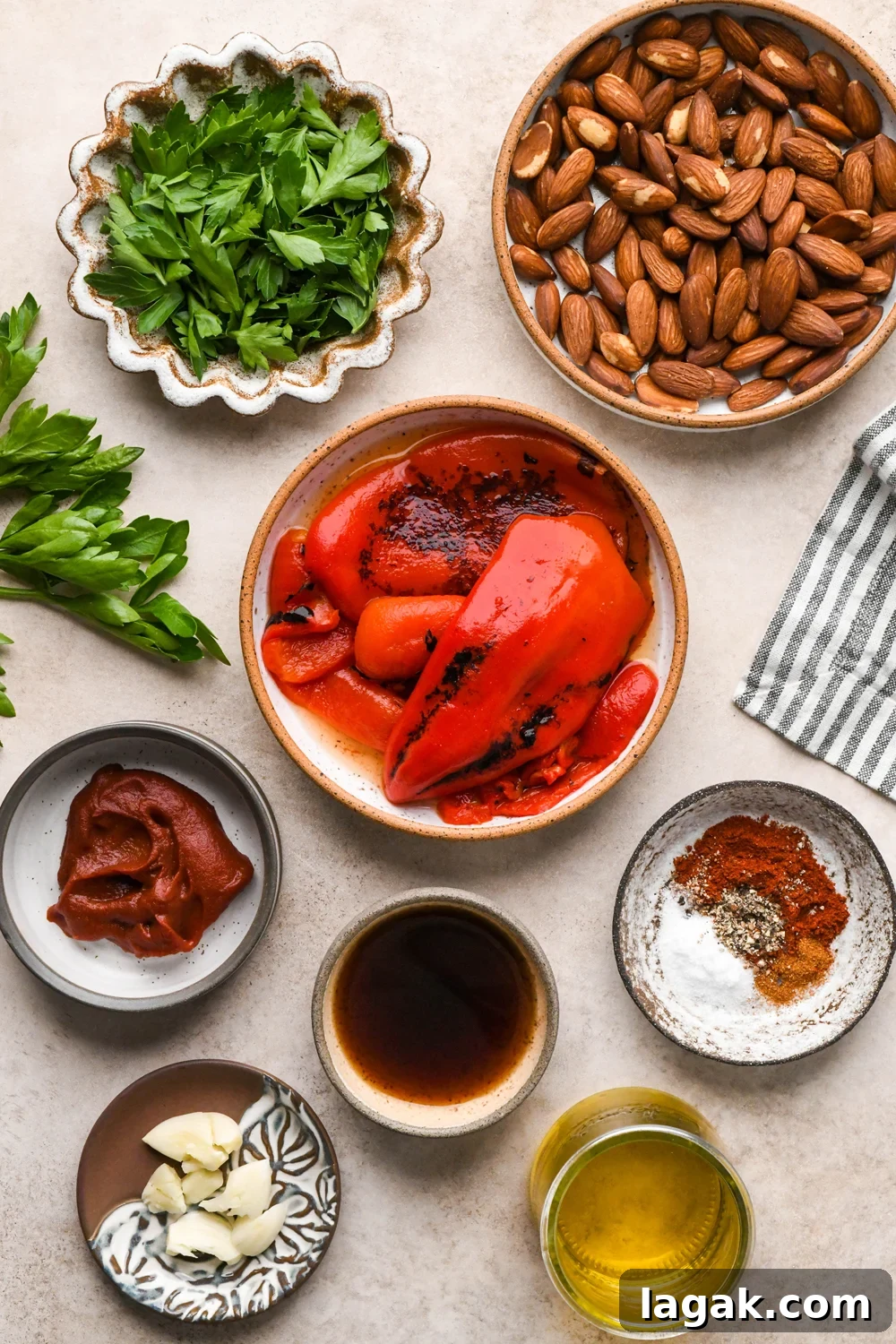 10-Minute Rustic Romesco Sauce (Dairy-Free) 4 Ingredients for dairy free romesco sauce in various ceramics on a light creamy brown background.