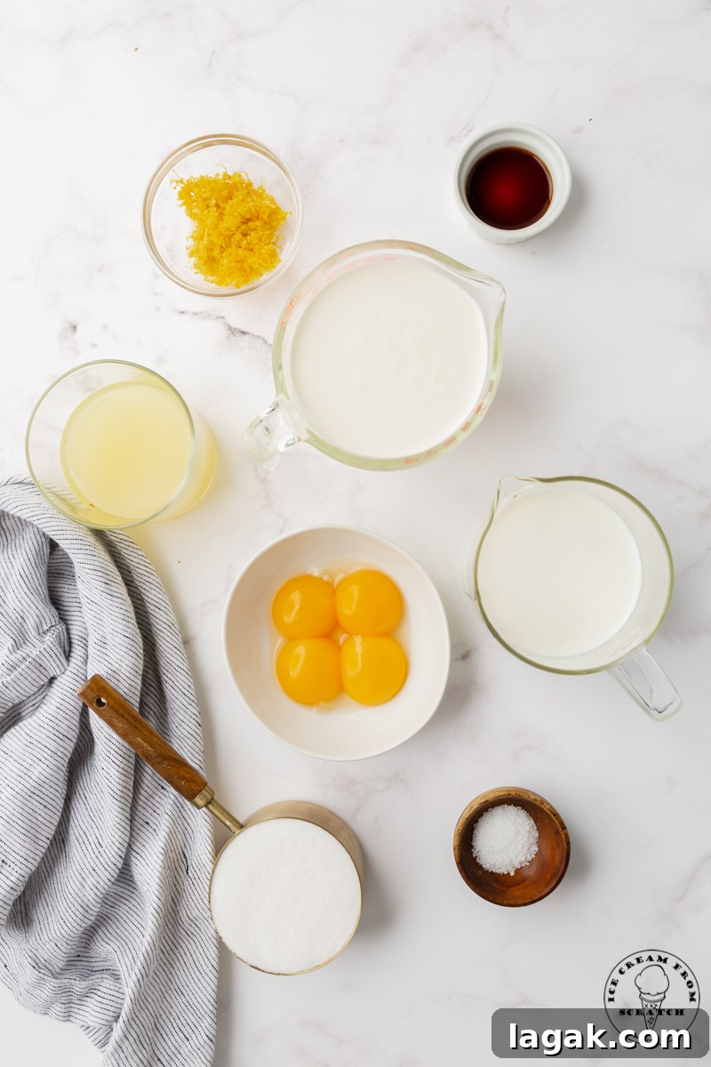 Creamy Lemon Ice Cream Recipe: Zesty Homemade Frozen Treat 3 the 8 ingredients needed to make lemon ice cream from scratch, all measured into small bowls on a marble countertop.