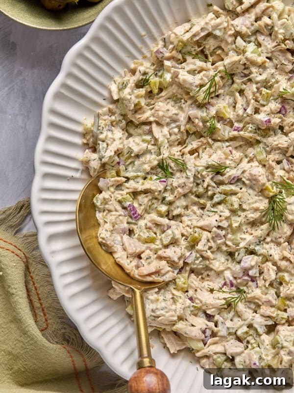High-Protein Buffalo Tuna Salad Recipe for Meal Prep 11 dill pickle chicken salad in a bowl with a gold and wooden serving spoon