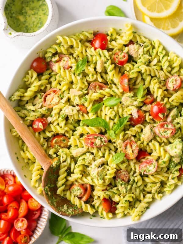 High-Protein Buffalo Tuna Salad Recipe for Meal Prep 12 pesto tuna pasta in a big bowl with a wooden spoon