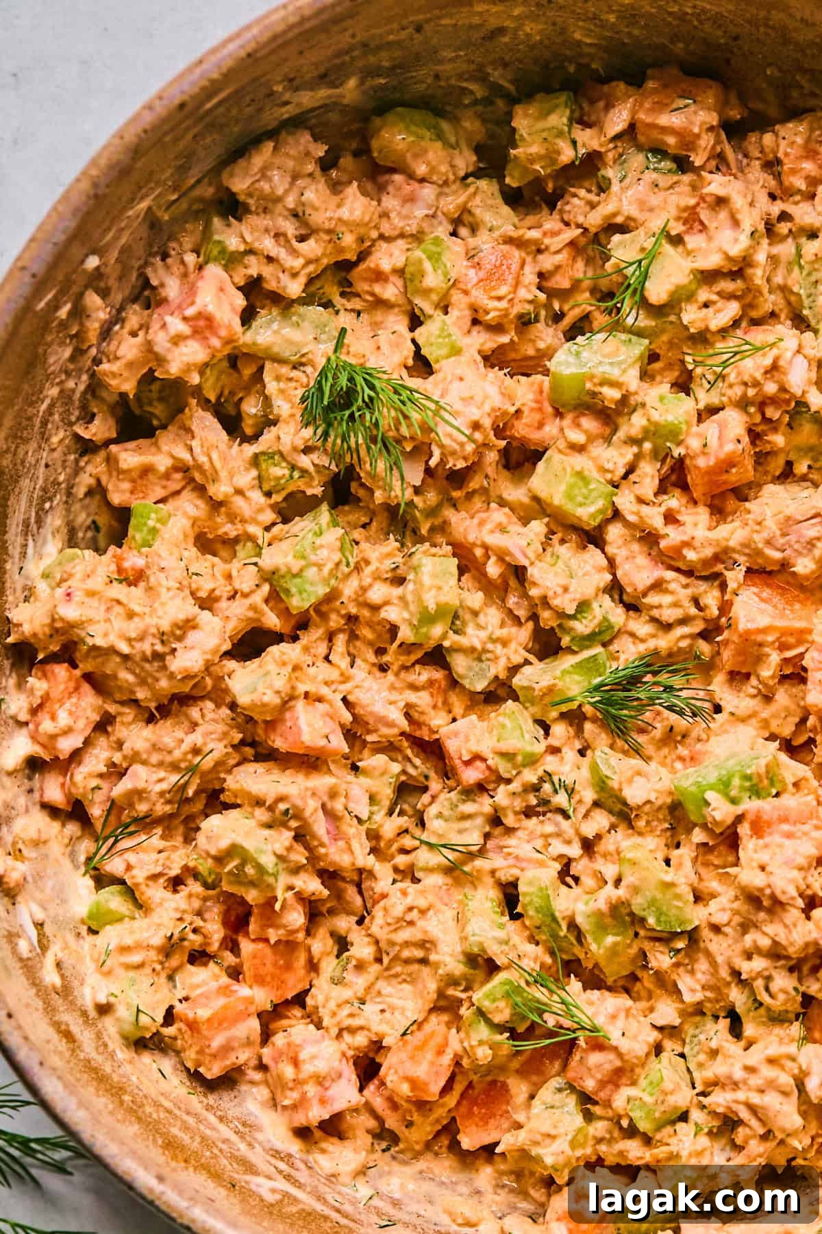 High-Protein Buffalo Tuna Salad Recipe for Meal Prep 9 a close up to show the texture and creaminess of the salad topped with fresh dill