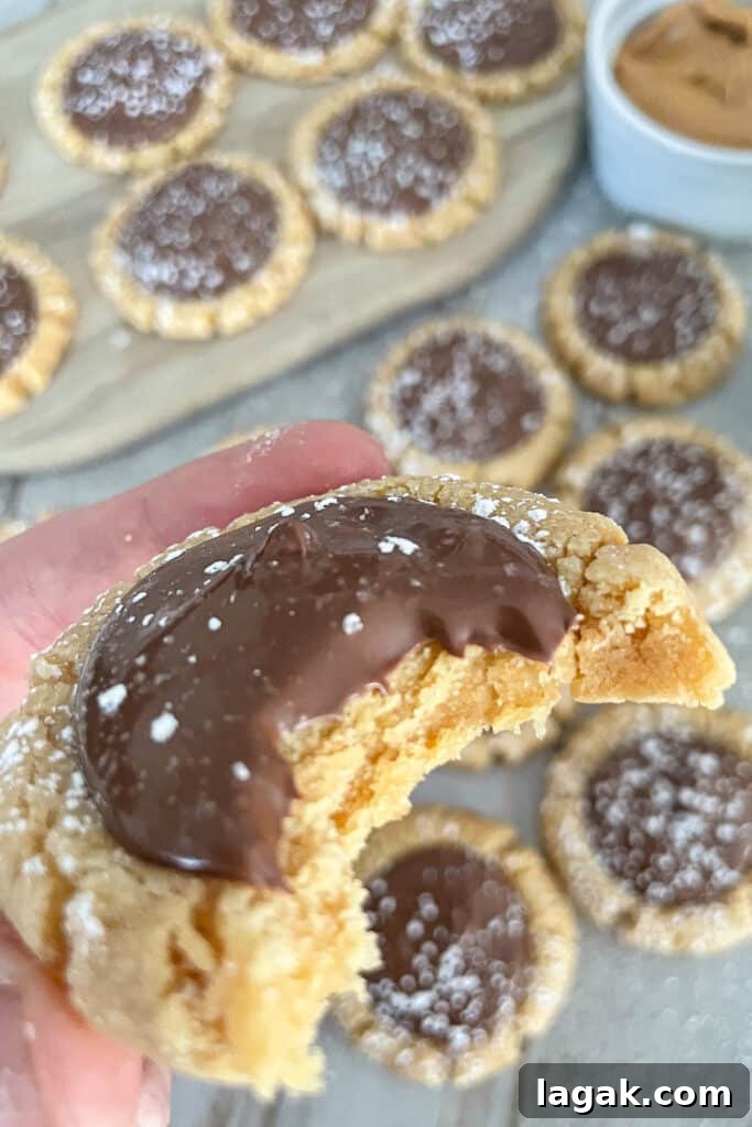 Muddy Buddy Cookie Recipe: No-Bake Peanut Butter Chocolate Treat 4 Close up shot of a single muddy buddy cookie with a bite taken out of the cookie