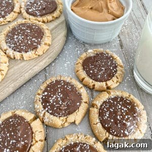 Muddy Buddy Cookies laid out flat with creamy peanut butter on the side