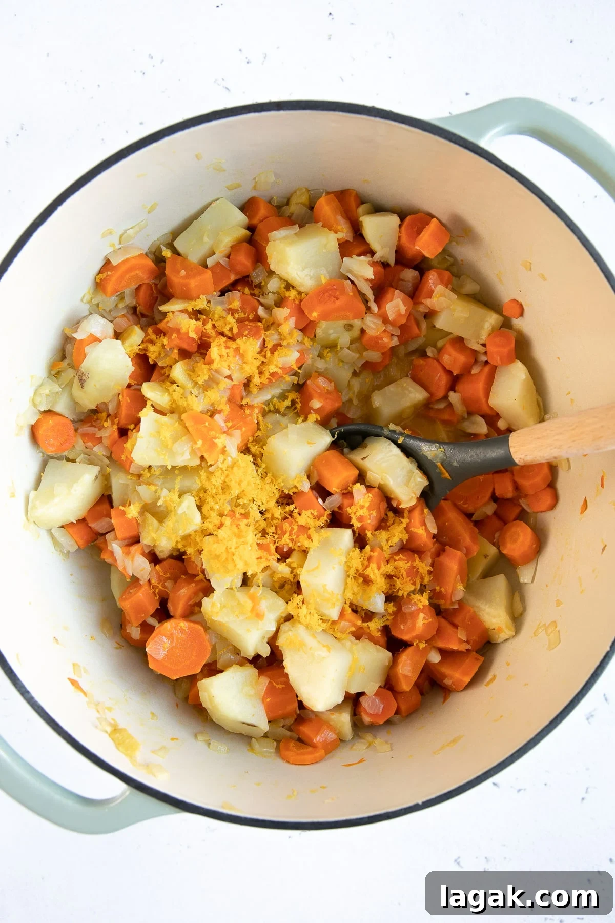 Creamy Carrot and Ginger Soup Recipe for Cozy Comfort 5 Carrots, onion, potato, ginger, and orange zest cooking in a large Dutch oven.